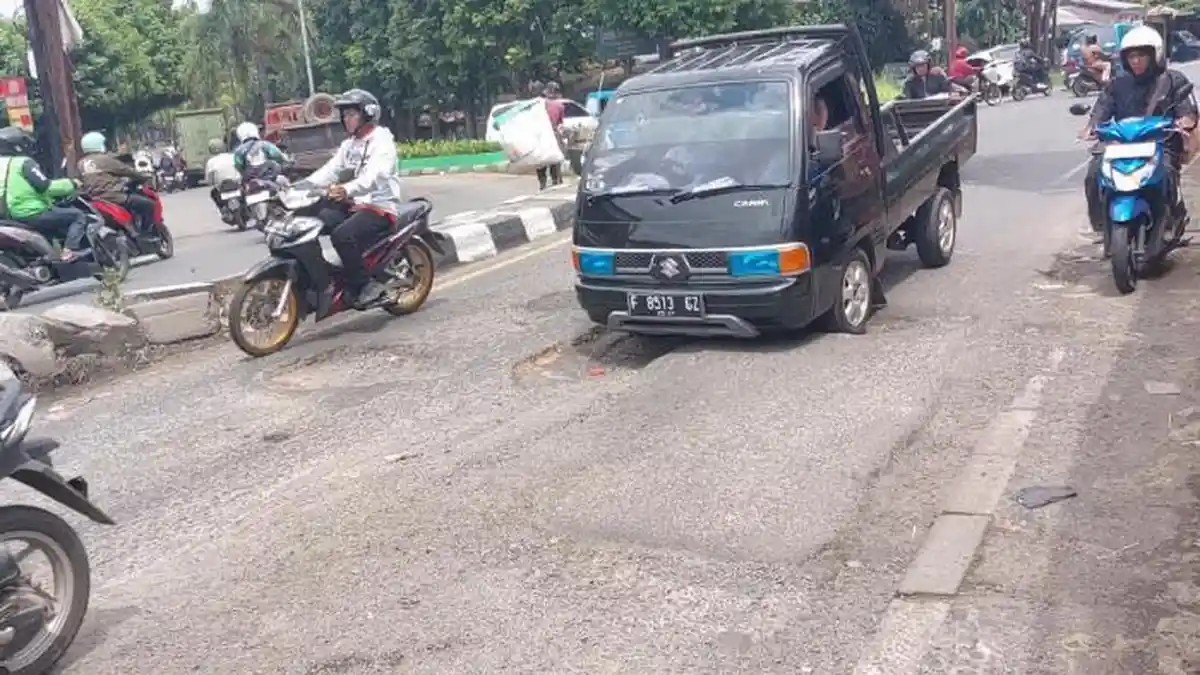 Duk! Bemper Mobil Nyangkut di Aspal Berlubang, Waspada Saat Lintasi Jalan Raya Cibadak-Ciampea Bogor